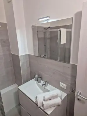 a bathroom with a sink and a mirror at MaGi Mondello in Mondello