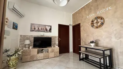 a living room with a flat screen tv on a wall at Mona House accogliente casa vacanza in Palermo