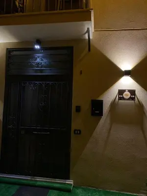 a black door with a light above it in a room at Holiday home Joy in Palermo