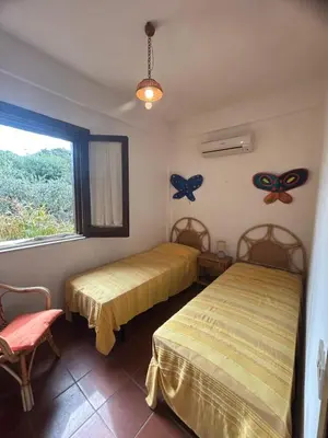 a bedroom with two beds and a window at La Terrazza su Pispisa in Castellammare del Golfo