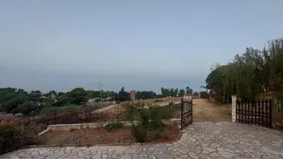 a gate in a field with a fence at La Terrazza su Pispisa in Castellammare del Golfo