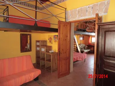 a living room with two bunk beds and a couch at Holiday home Santa Flavia in Santa Flavia