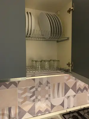 a kitchen with plates and glasses on a shelf at Albachiara Termini in Termini Imerese