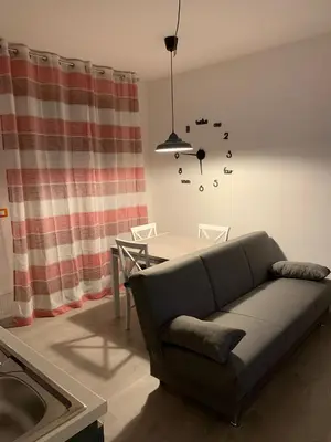 a living room with a couch and a table at Albachiara Termini in Termini Imerese