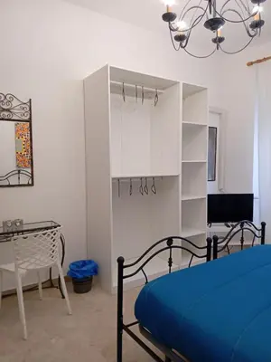 a bedroom with a bed and a table and a table at BBX Palermo 2 in Palermo