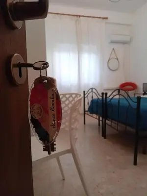 a room with two beds and a pillow hanging from a door at BBX Palermo 2 in Palermo