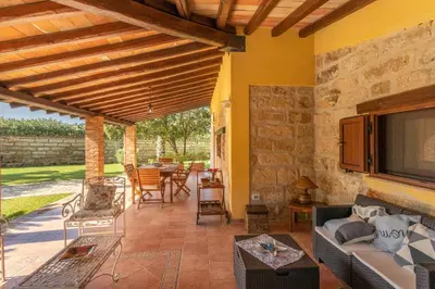 a living room with a couch and a tv on a patio at Villa Cecilia in Cinisi
