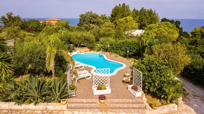 an aerial view of a swimming pool in a resort at Villa Reyna in Scopello