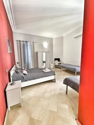 a bedroom with a bed and a living room at B&B Villareale 35 in Palermo