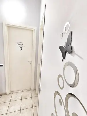 a butterfly on the wall next to a door at B&B Villareale 35 in Palermo