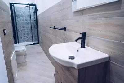 a bathroom with a sink and a toilet at Scorcio di Mare By Dimora Hub in Balestrate