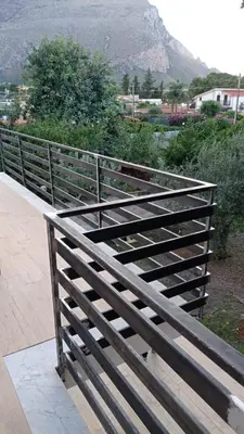 a wooden fence with a mountain in the background at Villa Francesca in Carini