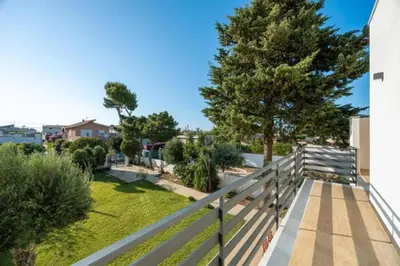 a balcony with a fence and a yard at Villa Francesca in Carini