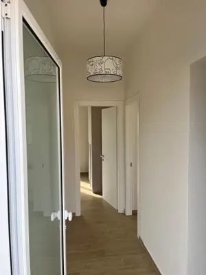 a hallway with a mirror and two lights at Villa Francesca in Carini