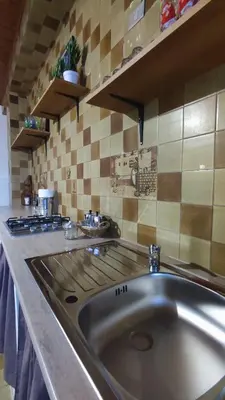 a kitchen with a sink and a stove at Casa Di Mitri in Carini