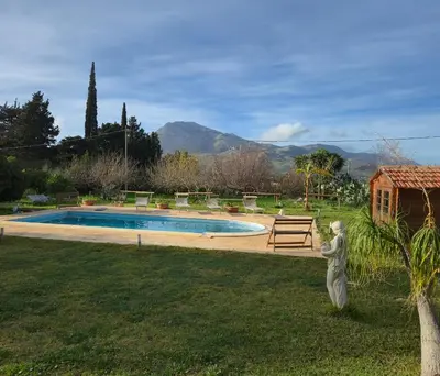 a pool in a yard with a statue in the grass at VILLa CON PISCINA SCOPELLO in Castellammare del Golfo