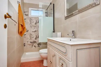 a bathroom with a sink and a toilet and a mirror at VILLa CON PISCINA SCOPELLO in Castellammare del Golfo