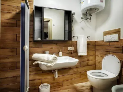 a bathroom with a toilet and a sink and a mirror at MaMa5 in Palermo