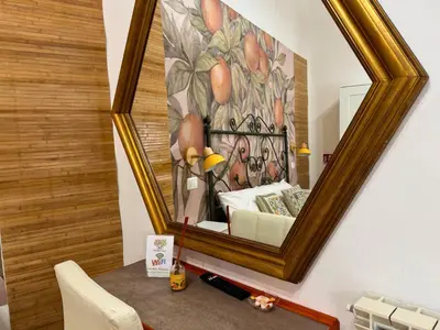 a mirror on a wall with a painting of a couch at Orange Lemon Center Palermo in Palermo