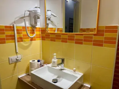 a bathroom with a sink and a mirror at Orange Lemon Center Palermo in Palermo