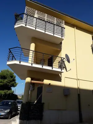 a balcony on the side of a building with a car at Casa L'ORIZZONTE in Balestrate