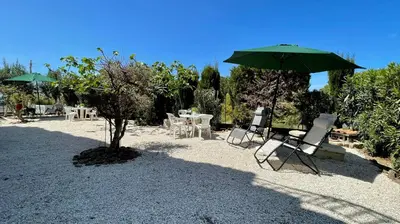 a patio with chairs and an umbrella and a table at Residence Cavalluccio Marino in Alcamo Marina
