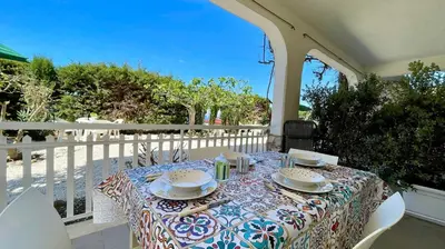 a table with plates and napkins on a balcony at Residence Cavalluccio Marino in Alcamo Marina