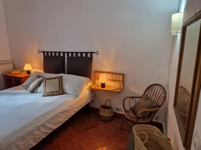 a small bedroom with a bed and a chair at Cathedral cozy apartment in Palermo