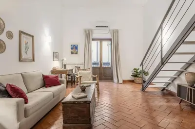 a living room with a couch and a table at Cathedral cozy apartment in Palermo
