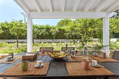 a wooden table with a bowl of fruit on it at Villa NìMia in Castellammare del Golfo