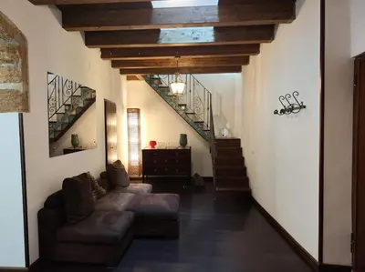 a living room with a couch and a staircase at Casa Bosco a Ballarò in Palermo