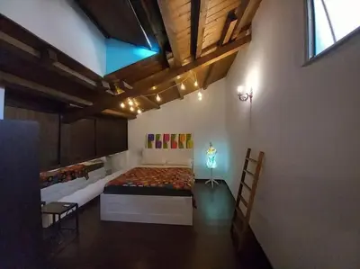 a large room with a bed and a table and chairs at Casa Bosco a Ballarò in Palermo