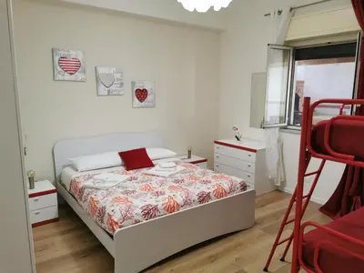 a bedroom with a bed and a red ladder at Holiday House Nonna Grazia in Trappeto
