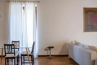 a living room with a table and a couch at Cavour Elegant apartment At Massimo Theater in Palermo