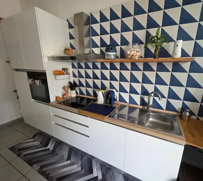 a small kitchen with a sink and a microwave at 'a casetta - Sferracavallo in Palermo