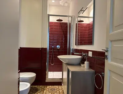 a bathroom with a sink and a toilet and a shower at Victoria's Apartment in Palermo