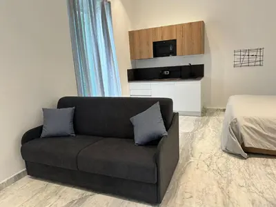 a living room with a couch and a bed at Lily Suite in Palermo