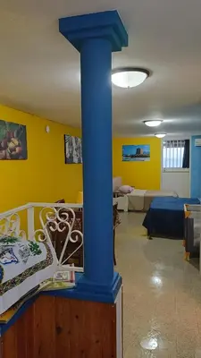 a blue column in a room with a living room at LA TERRAZZA SUL MARE monolocale con terrazza vicino aereoporto&mare SICILIAN VINTAGE STYLE BEACH HOUSE in Cinisi