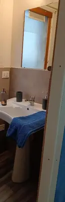 a bathroom with a sink with a blue towel on it at LA TERRAZZA SUL MARE monolocale con terrazza vicino aereoporto&mare SICILIAN VINTAGE STYLE BEACH HOUSE in Cinisi