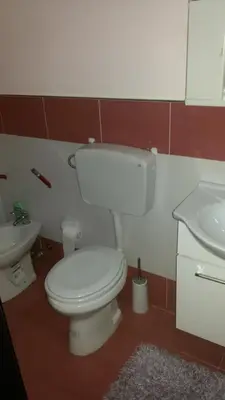 a bathroom with a white toilet and a sink at Holiday Home Villa Relax in Palermo