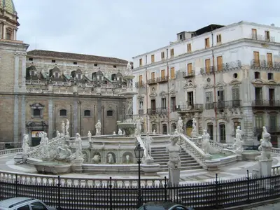a fountain in the middle of a city with buildings at Holiday Home Villa Relax in Palermo