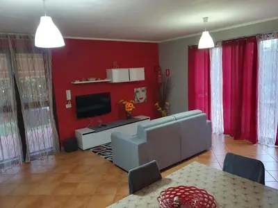 a living room with a couch and a television at Holiday Home Villa Relax in Palermo