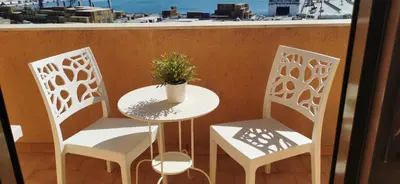 a bedroom with a bed and a large window at Port Side Elegance Palermo in Palermo