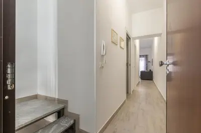 a hallway with white walls and a wooden floor at Casa Brunaccini con Terrazza by Wonderful Italy in Palermo