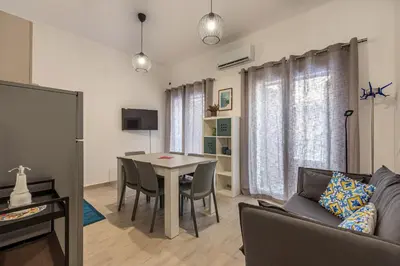 a living room with a table and a couch at Casa Brunaccini con Terrazza by Wonderful Italy in Palermo