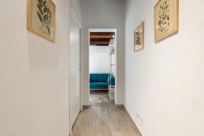 a hallway with white walls and a blue couch at Casa Brunaccini con Terrazza by Wonderful Italy in Palermo