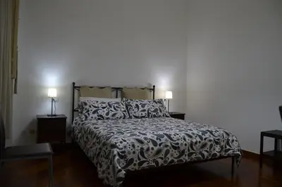 a bedroom with a bed and two lamps on tables at B&B Paolo e Mariella in Palermo