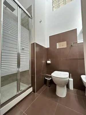 a bathroom with a toilet and a glass shower at B&B Paolo e Mariella in Palermo