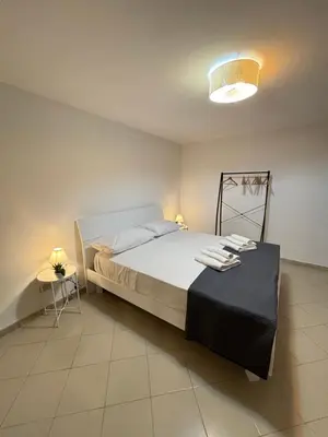 a bedroom with a bed and a table in it at A Due Passi da Mondello in Palermo