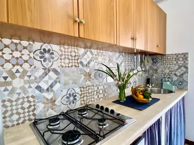 a kitchen counter with a stove top in a kitchen at Le Case di Anan, Castellammare del Golfo in Castellammare del Golfo
